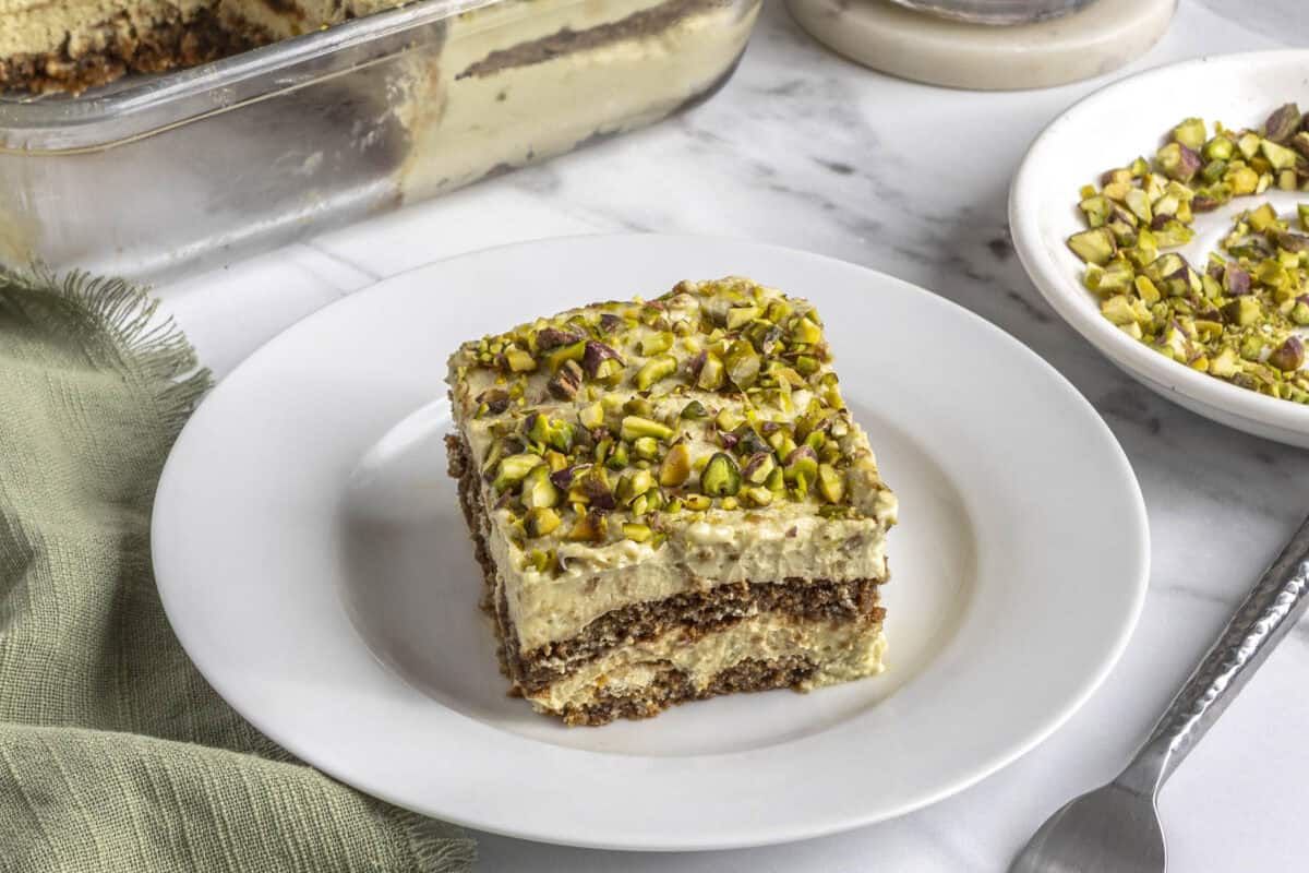 Slice of homemade pistachio tiramisu on a plate.