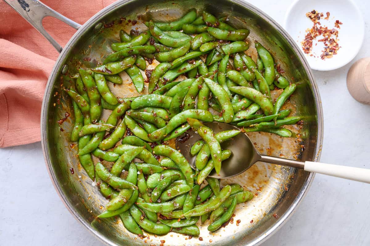 Easy spicy garlic edamame recipe in a skillet.