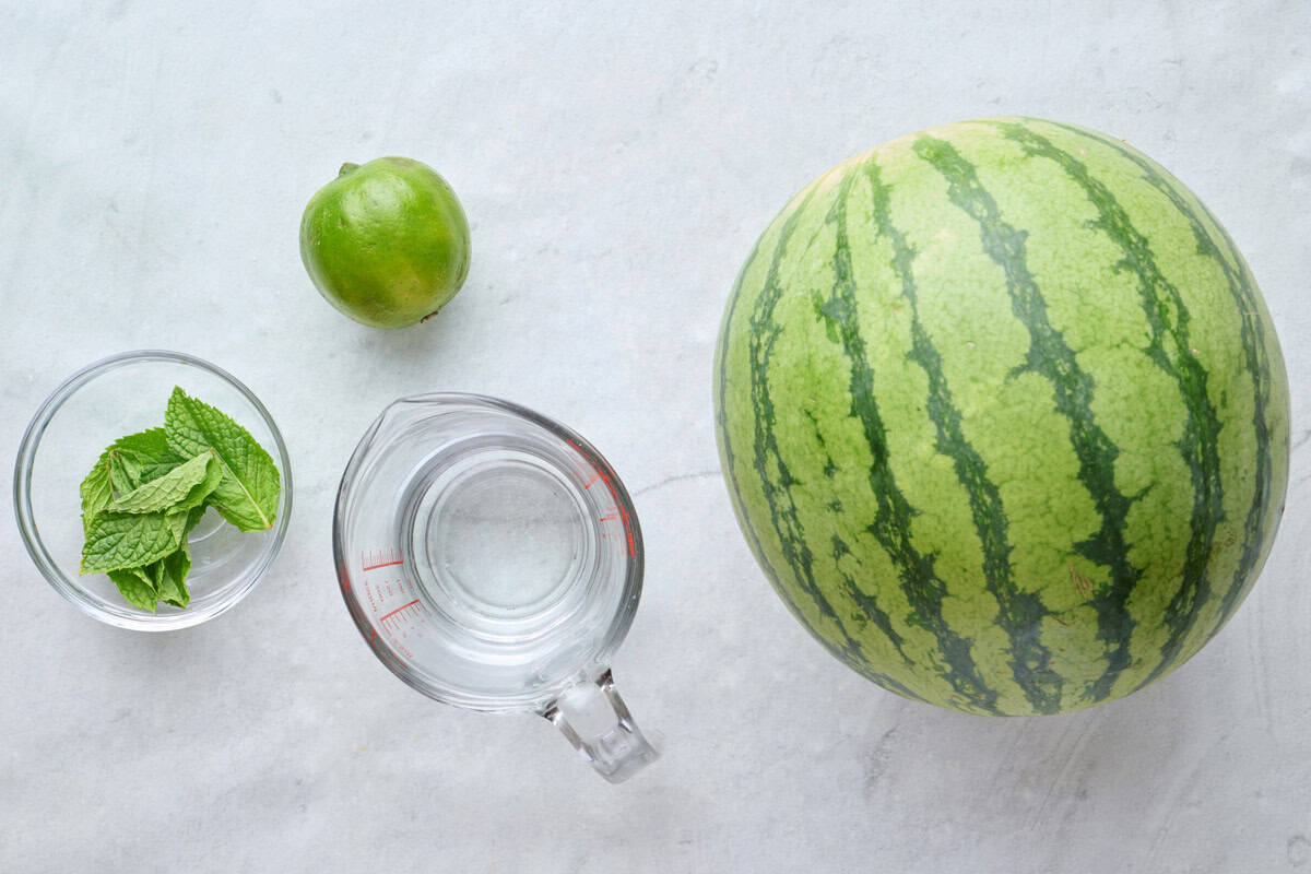 Ingredients for recipe: fresh mint, lime, cold water, and seedless watermelon.
