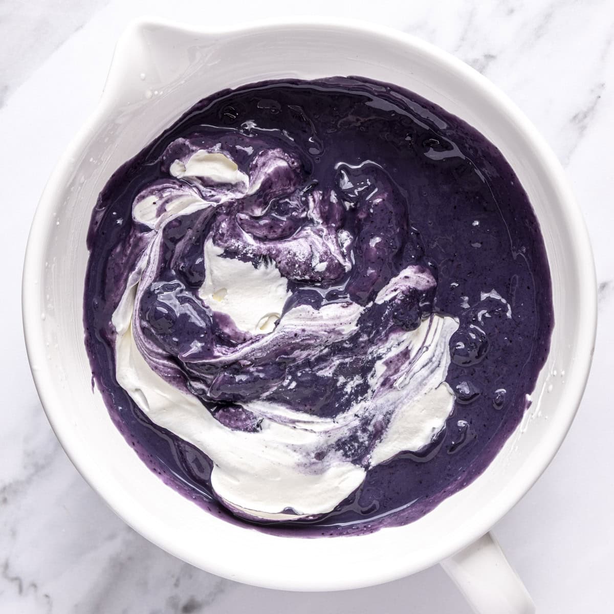 Blueberry mixture added to whipped cream.