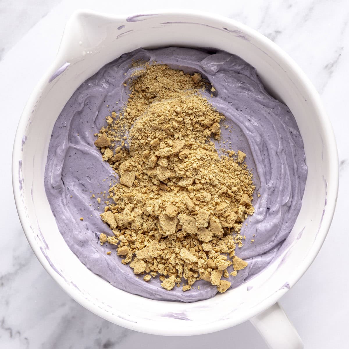 Graham cracker crumbs added to soft blueberry cream.