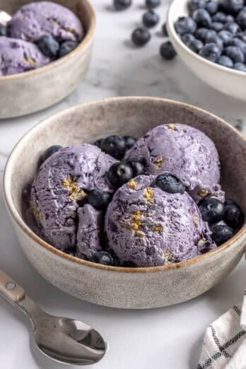 Homemade fresh blueberry ice cream with graham crackers in a bowl.