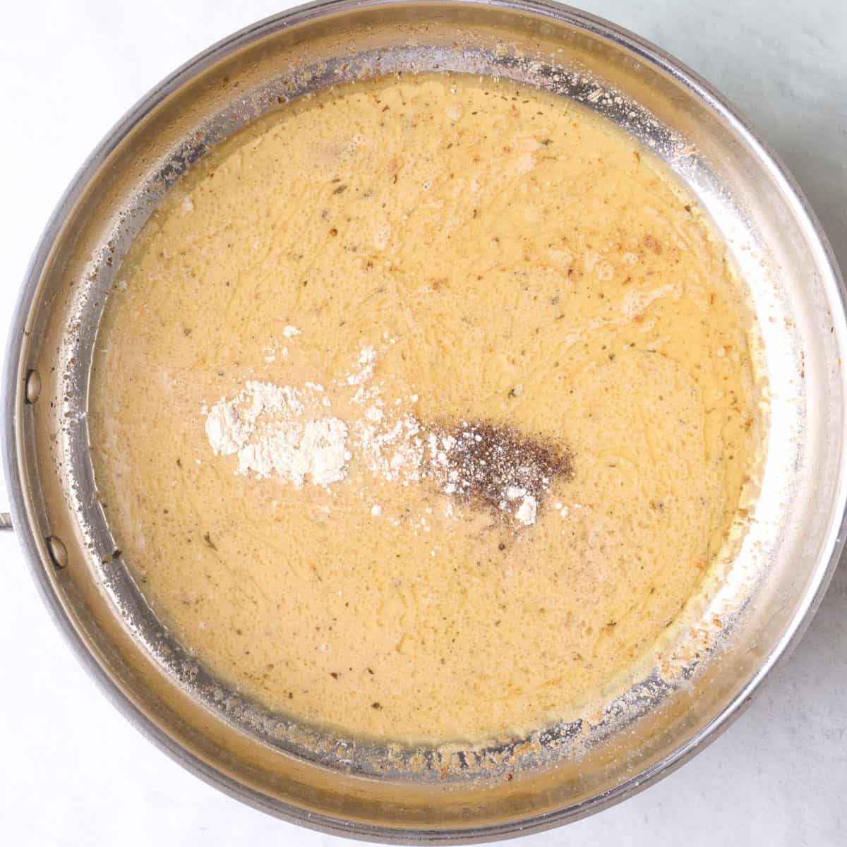 Sauce after combined with salt, pepper and garlic powder added on top.