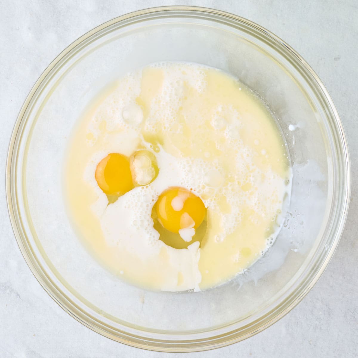 Melted butter, eggs and butter in a bowl.