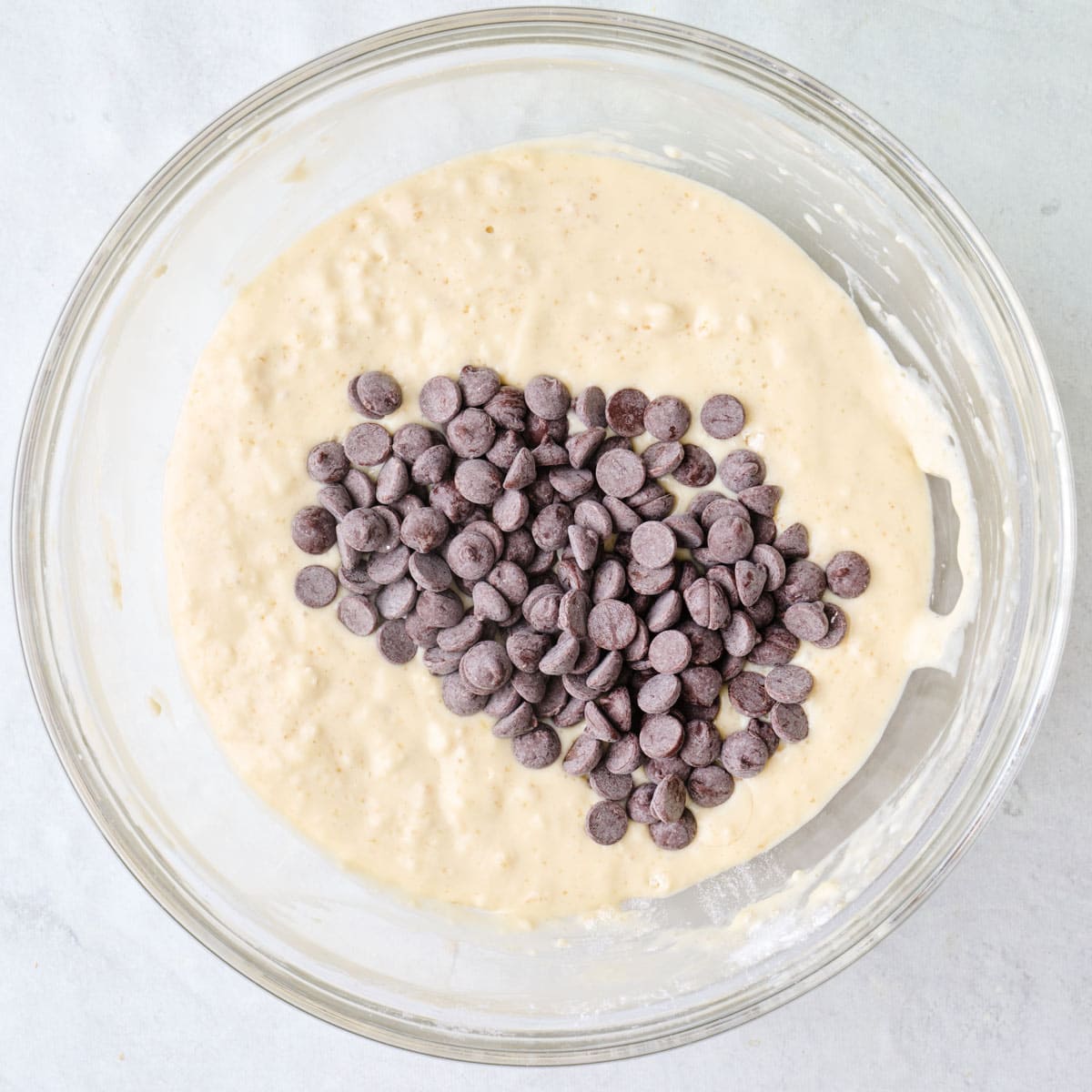 Pancake batter in a bowl with chocolate chips added.