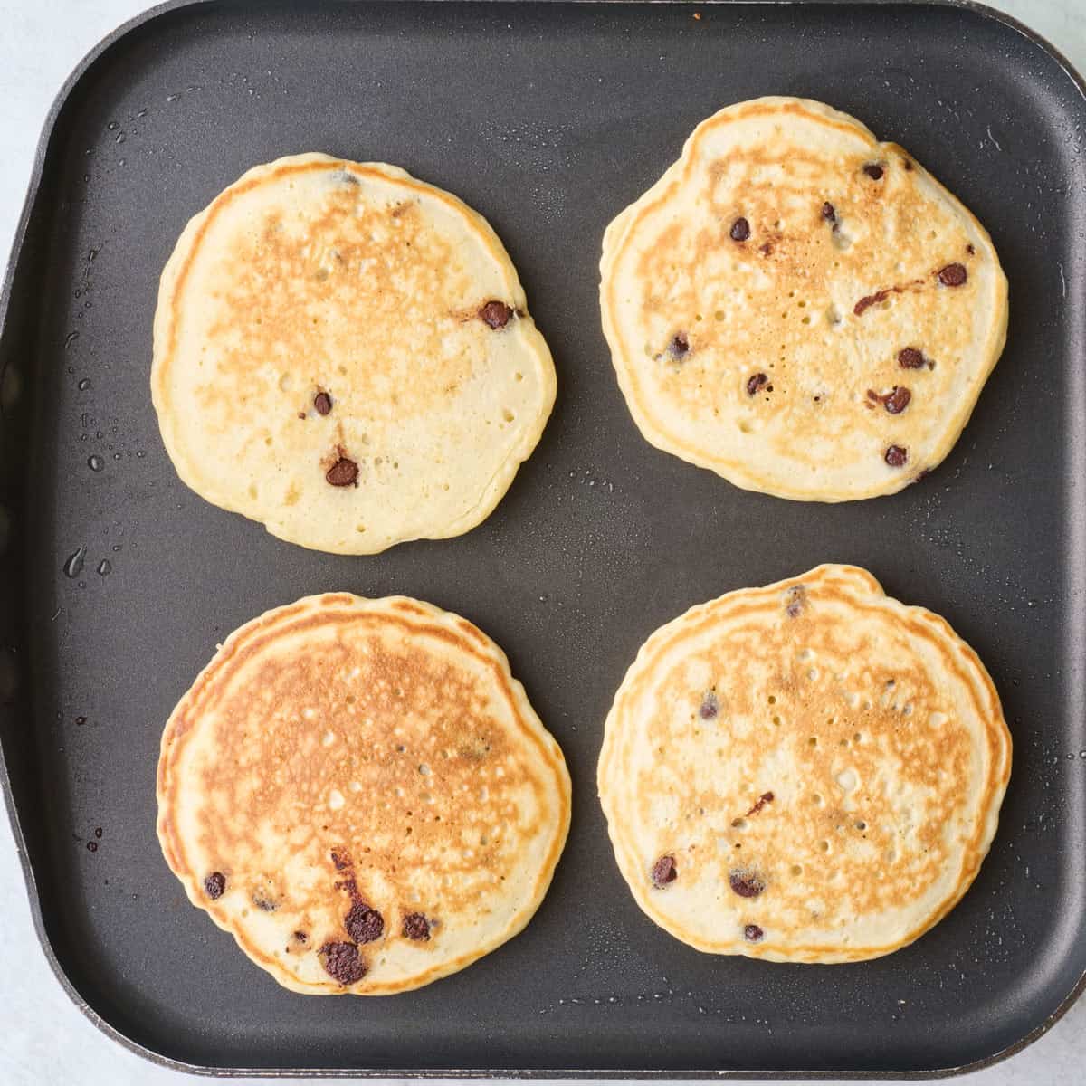Pancakes after flipping on griddle.