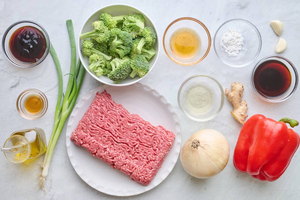 Ingredients for recipe: oyster sauce, honey, oil, green onions, broccoli florets, ground beef, rice vinegar, toasted sesame oil, cornstarch, garlic, soy sauce, ginger, onion, and bell pepper.
