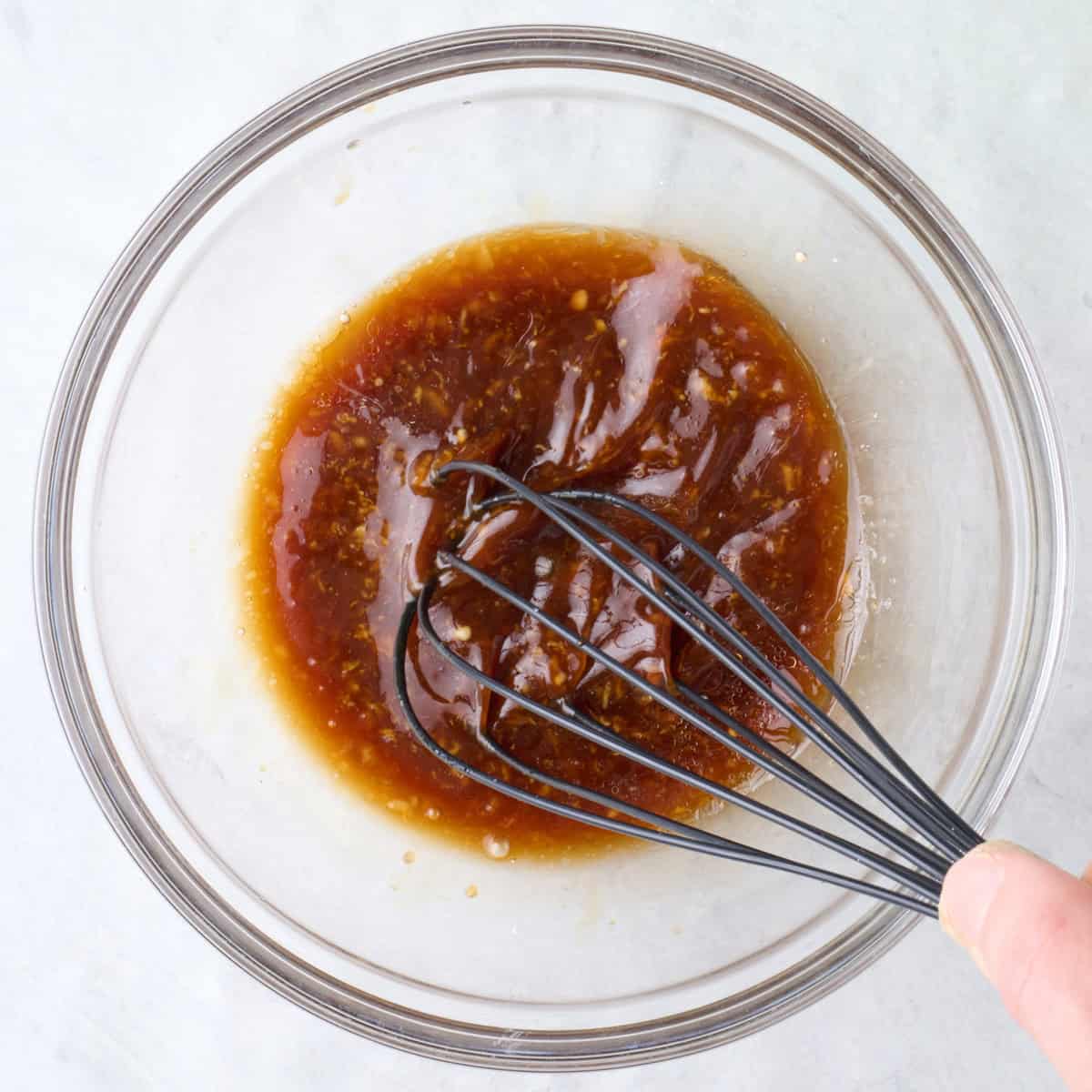 Sauce being whisked in a bowl.