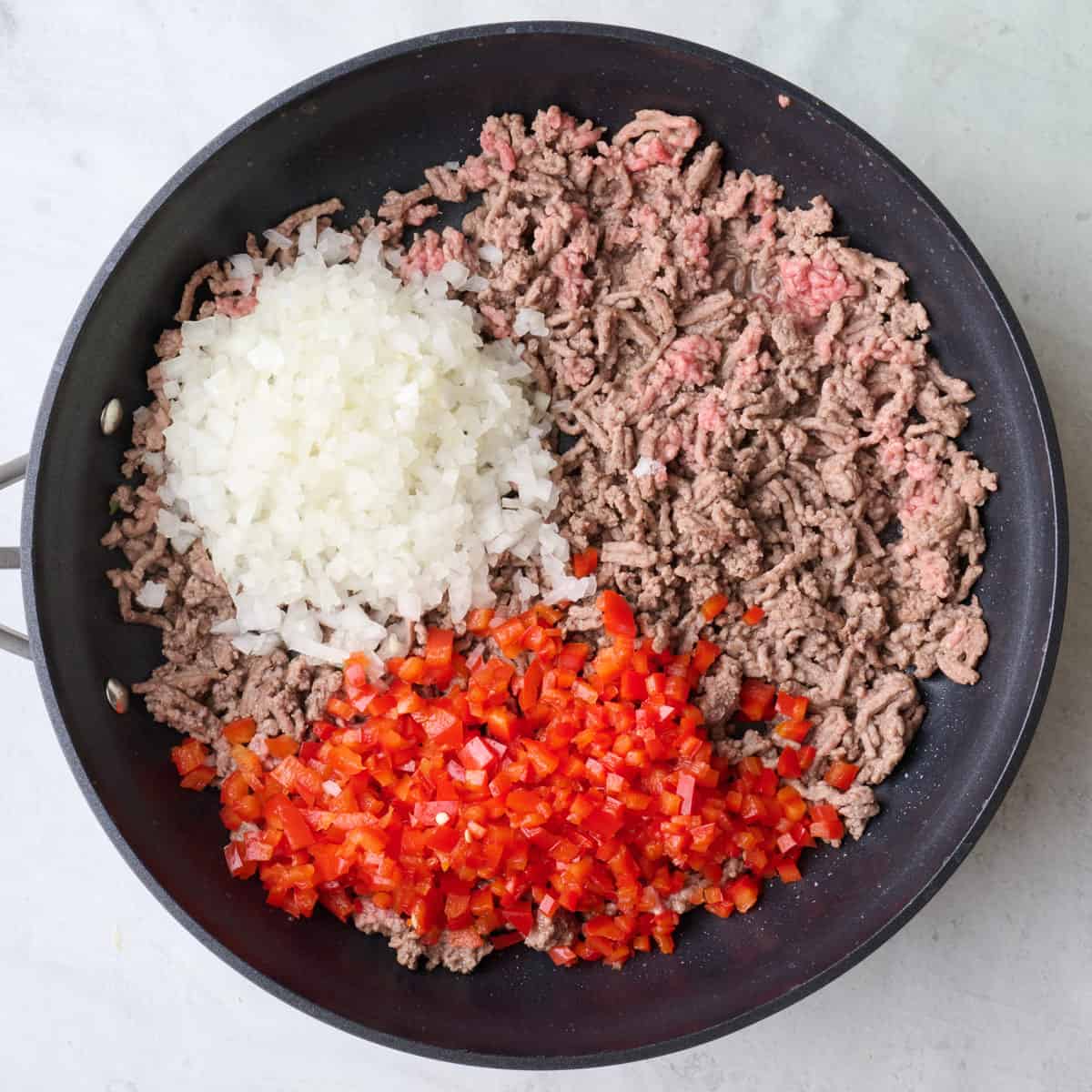 After cooking half way with chopped onion and red pepper added.