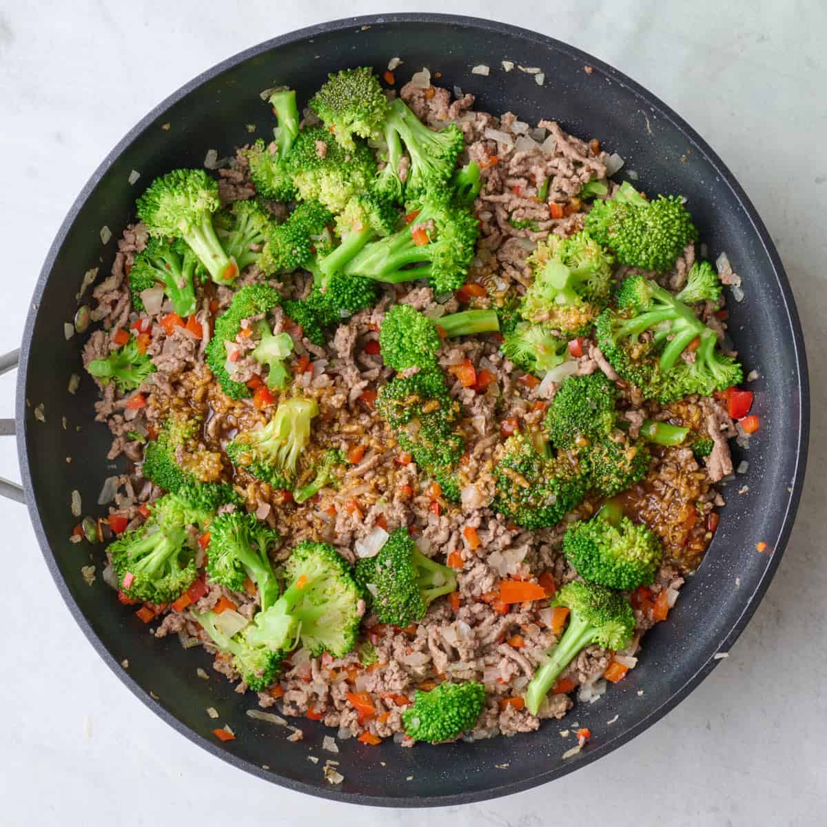 After broccoli added and cooked with sauce poured over.