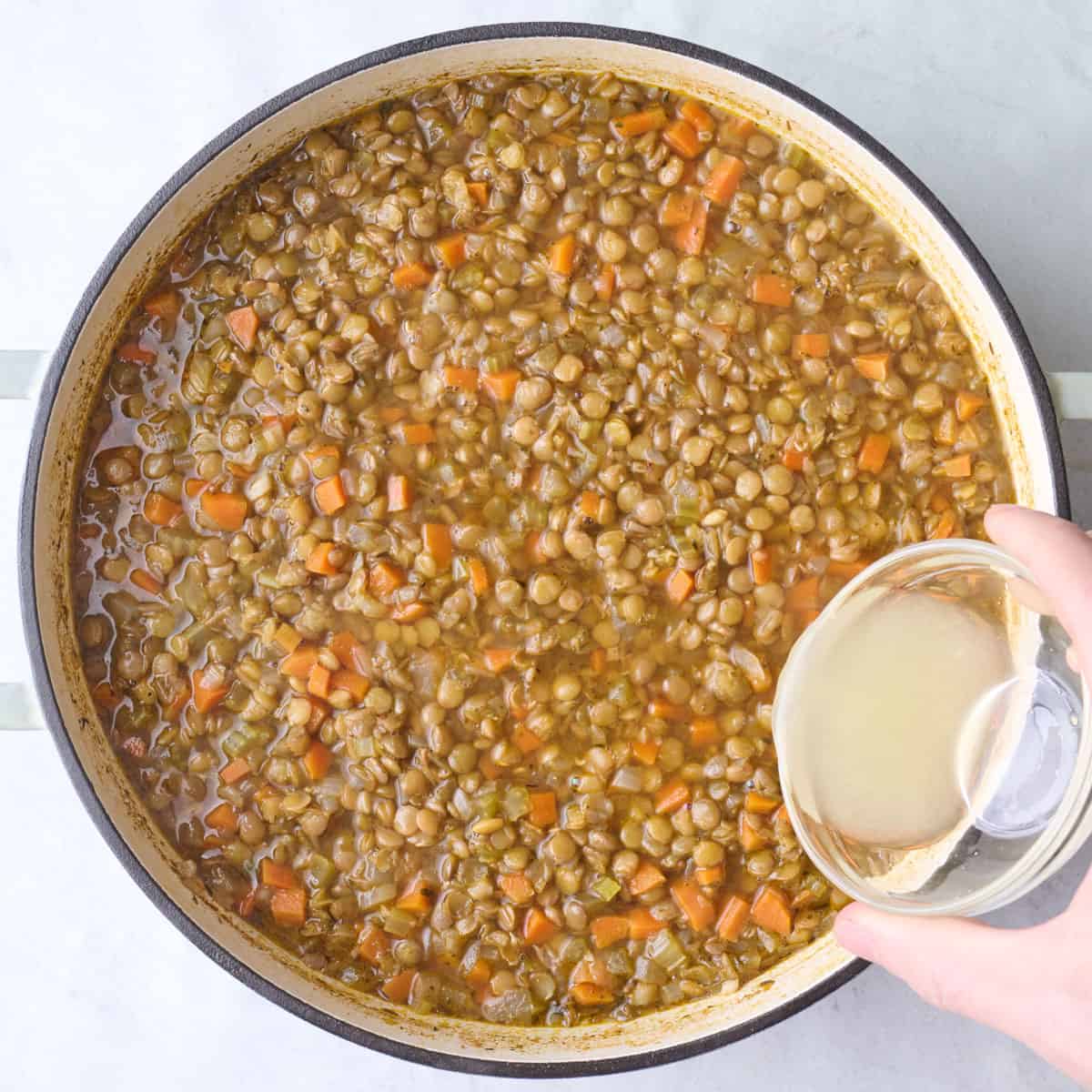 After soup has simmered, lemon juice being added.