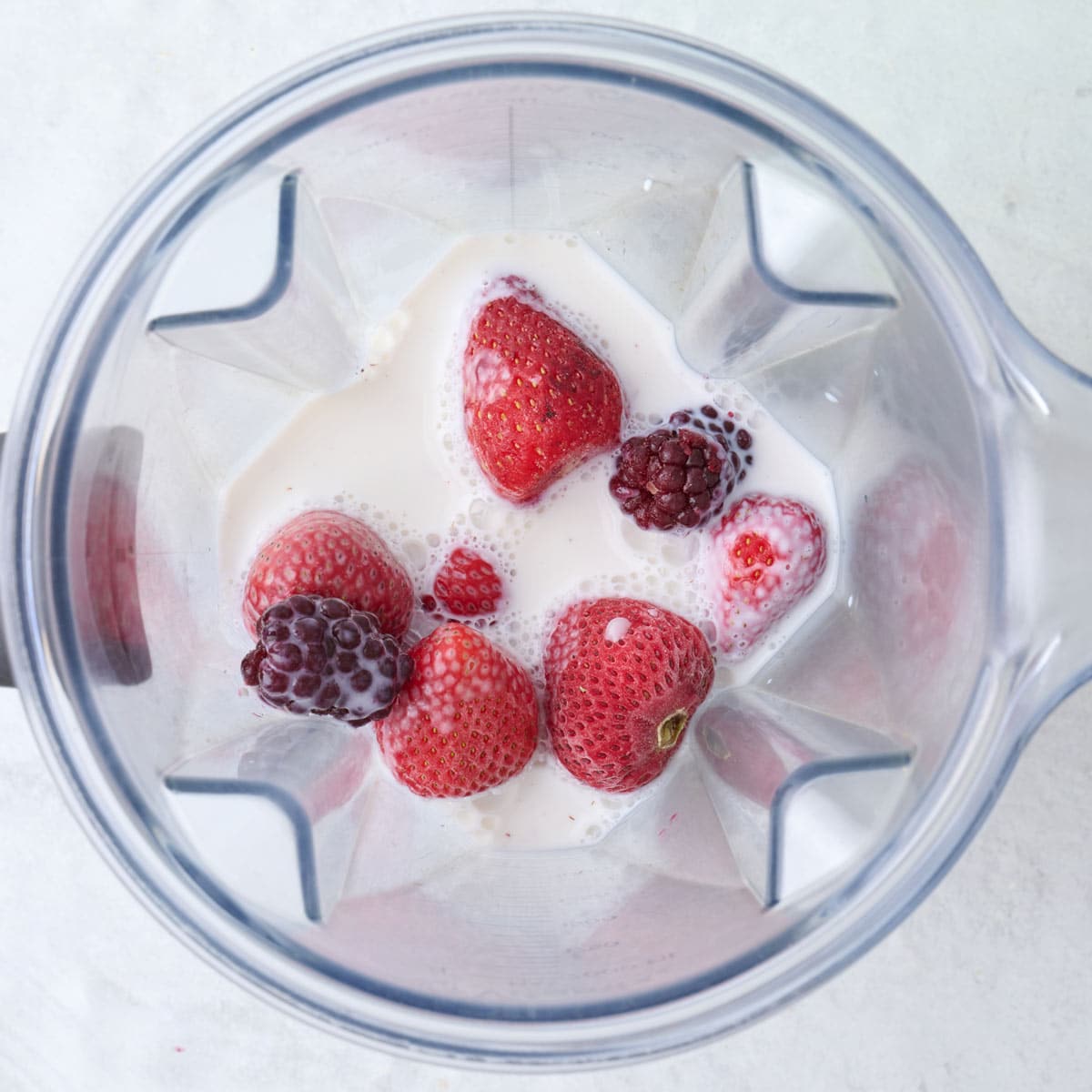 Smoothie ingredients in a blender before blending.