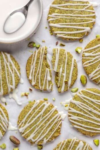 Homemade pistachio cookies with white chocolate drizzle.