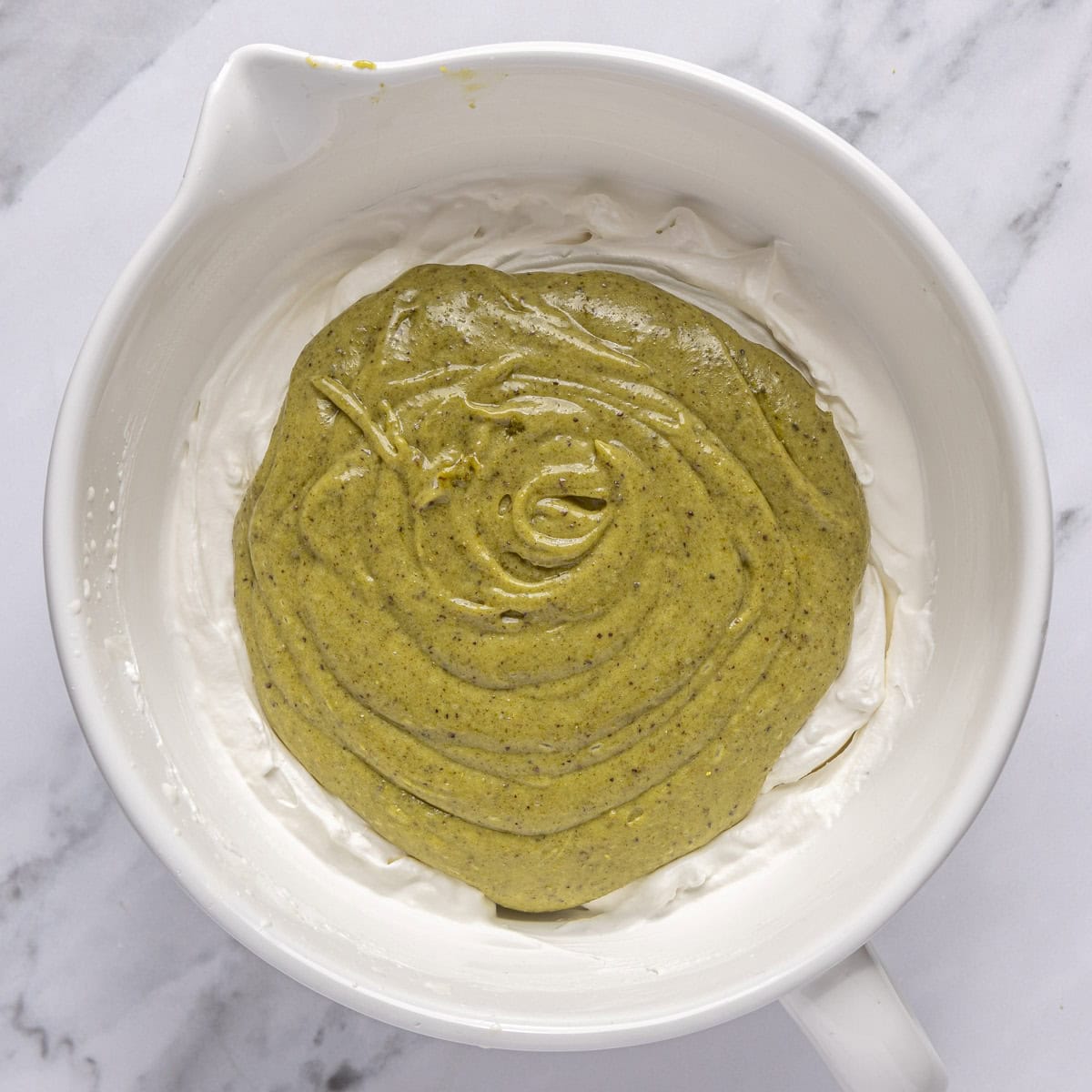 Pistachio mixture added to bowl with whipped cream.