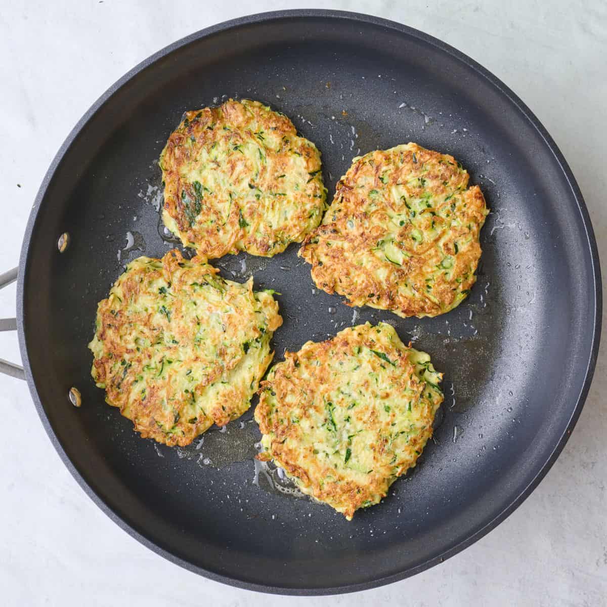 After flipping fritters in a skillet.