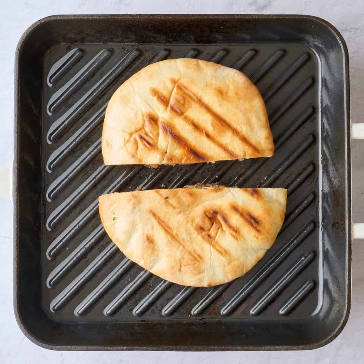 After flipping to show golden crust pita.