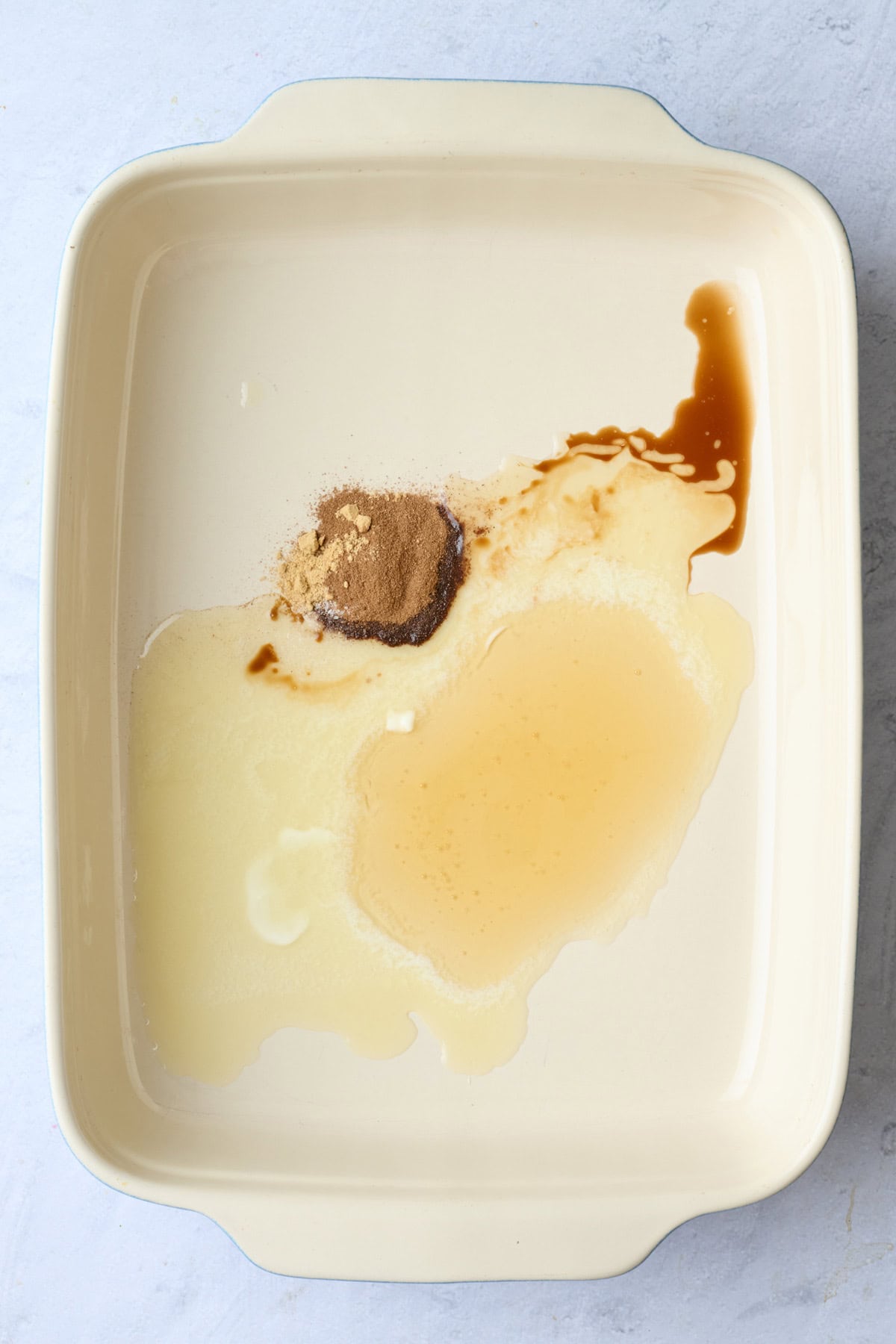Melted butter, honey, vanilla, cinnamon, ginger and salt in a baking dish.