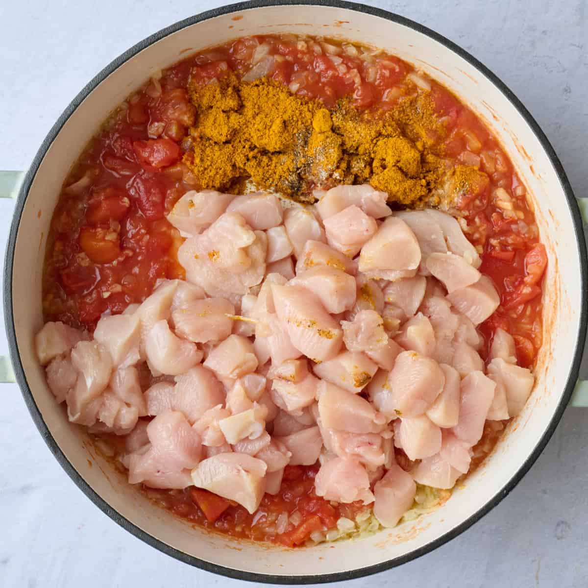 Diced chicken breast, curry powder, salt and pepper added to pot with veggies.