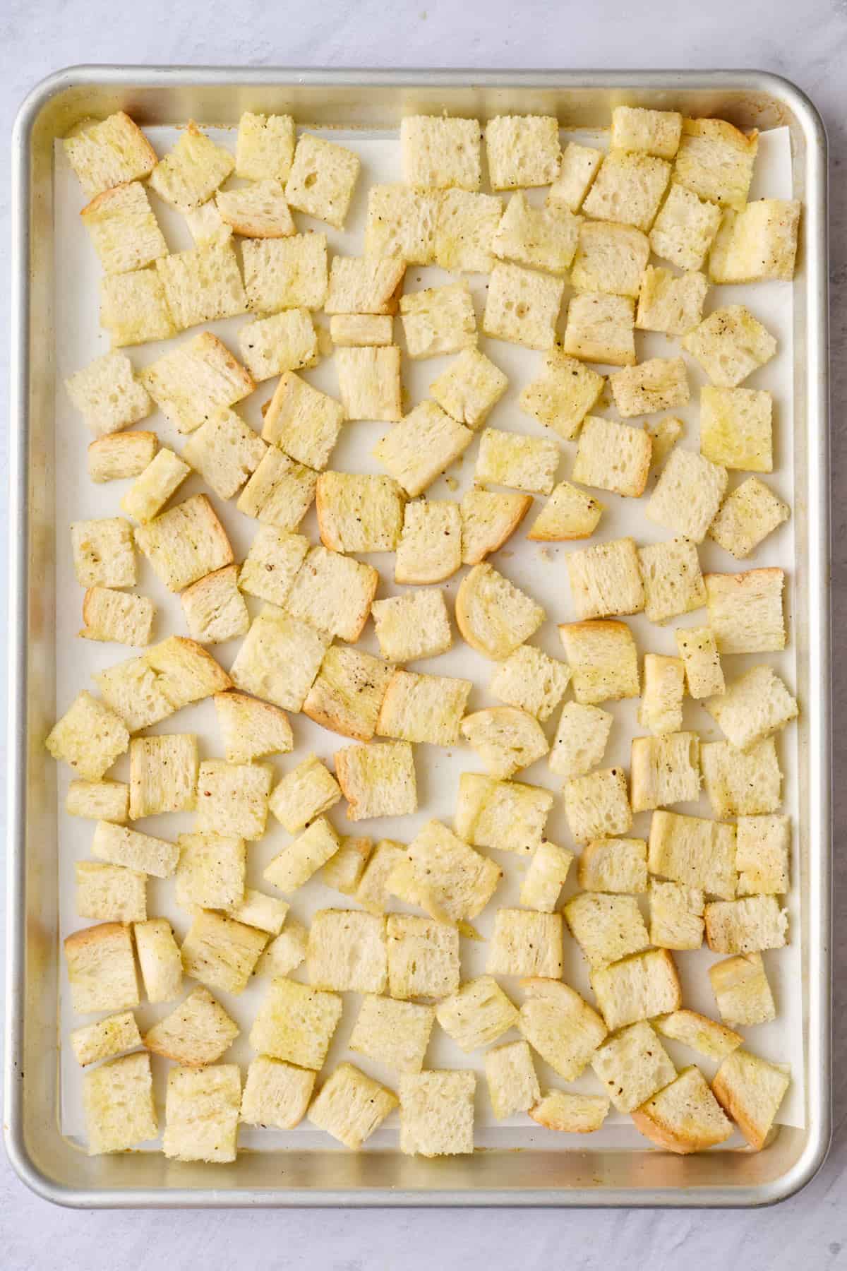 Recipe on a sheet pan tossed with oil.