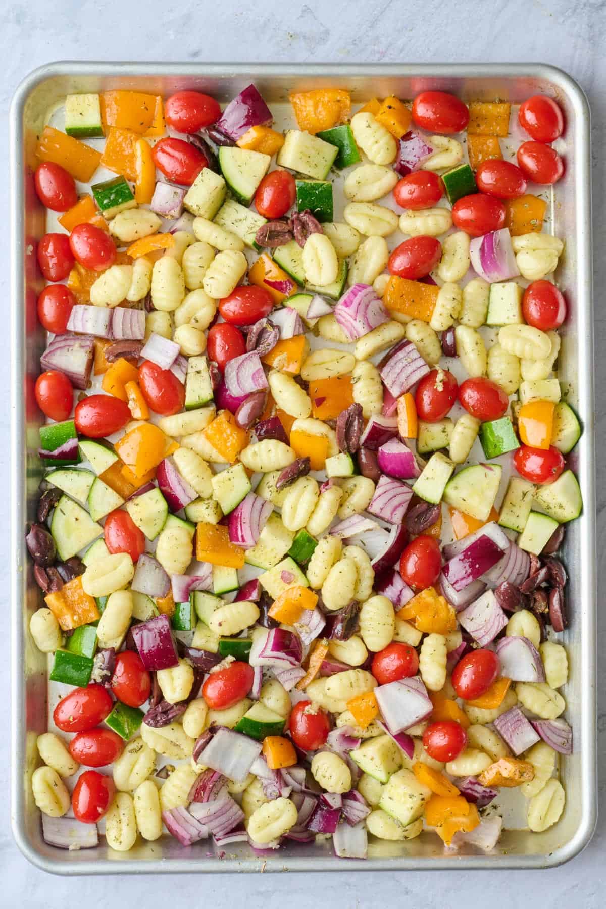 Recipe after tossing with oil and seasonings on a sheet pan.
