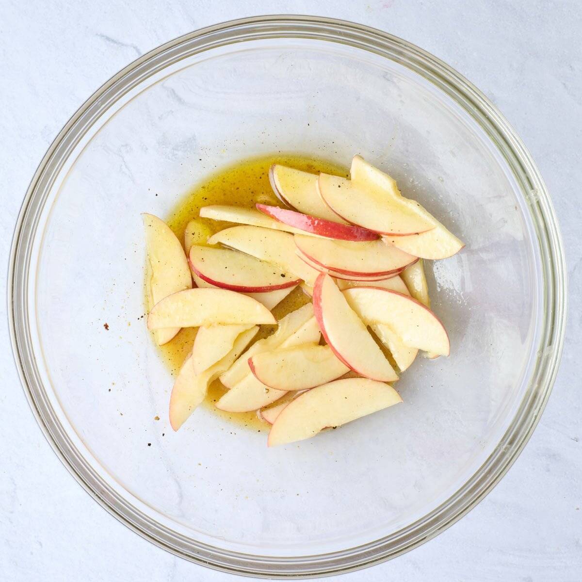 Dressing after mixed with sliced apples added and coated in dressing.