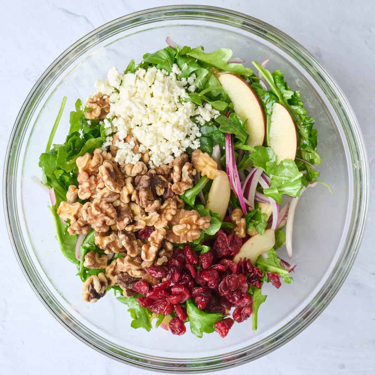 Salad ingredients in bowl before tossing together.
