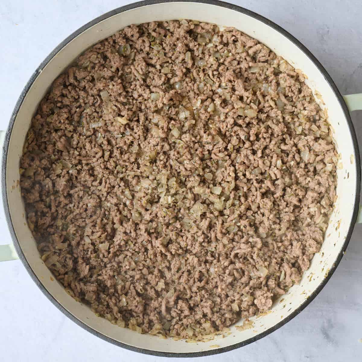 Browned ground beef in pot.