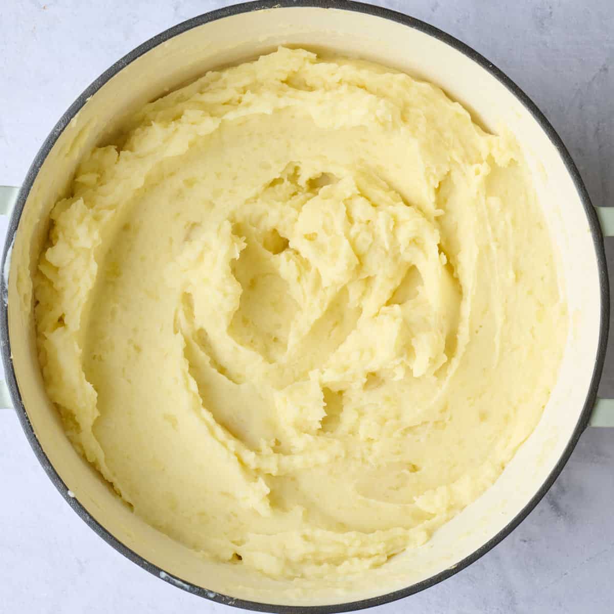 Creamy mashed potatoes in pot.