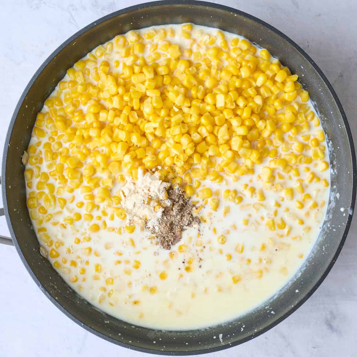 After sauce has thickened with corn and seasonings added.