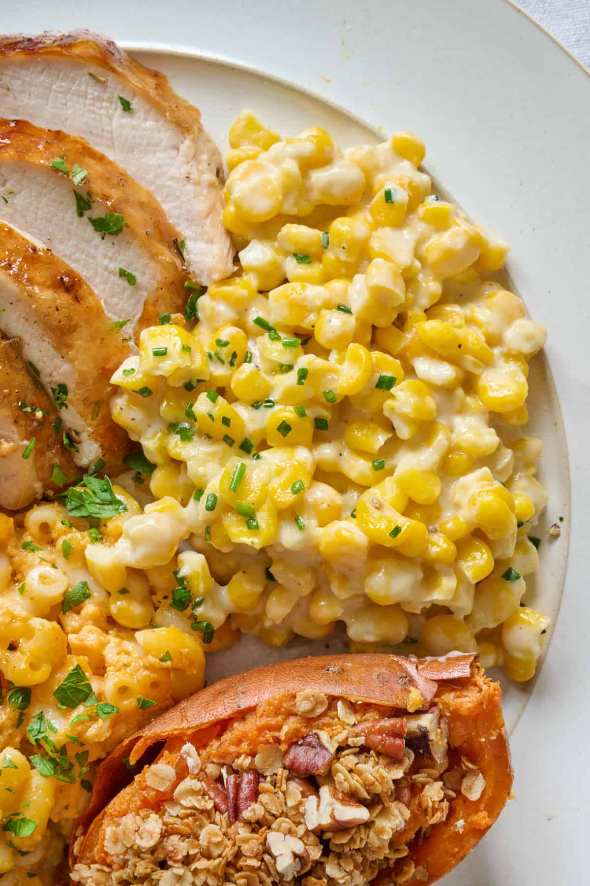 Serving of creamed corn on a dinner plate.