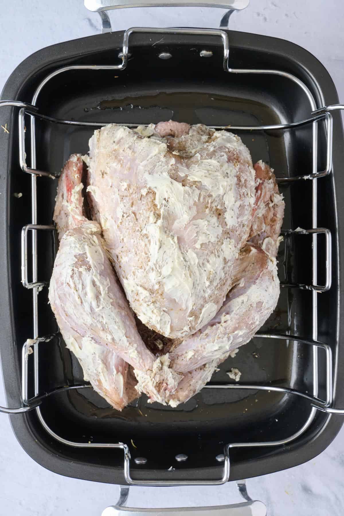 Softened butter rubbed over turkey.