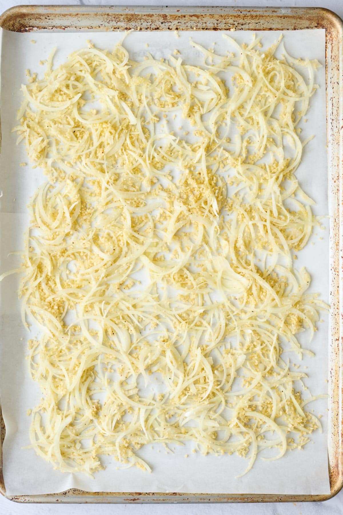Sliced onions tossed with breading before cooking.