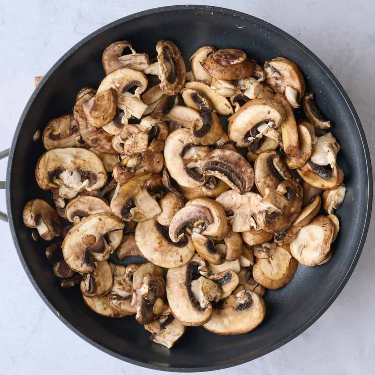 Mushrooms and oil in a large skillet.