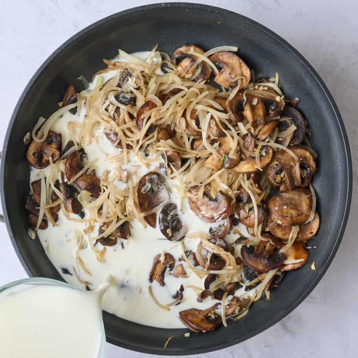 Milk and slurry added to sauteed veggies in pan.