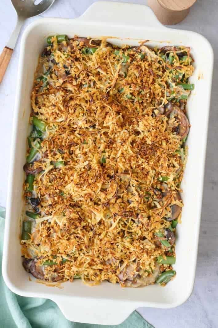 Best green bean casserole in a baking dish with a homemade crispy onion topping.