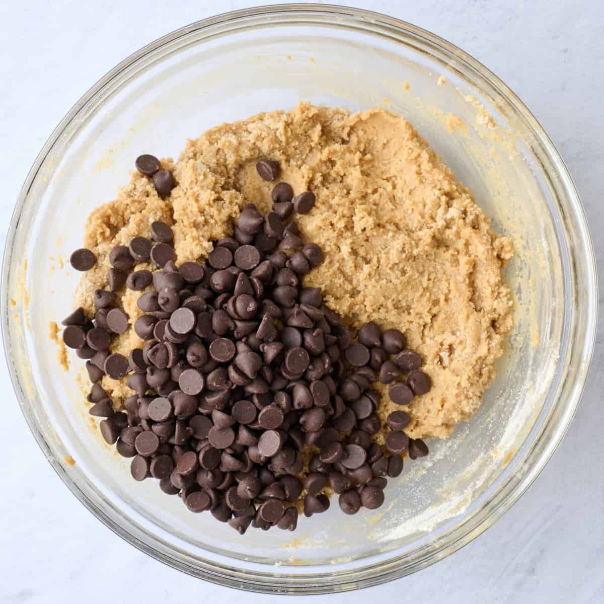 Cookie dough base in a bowl with chocolate chips.