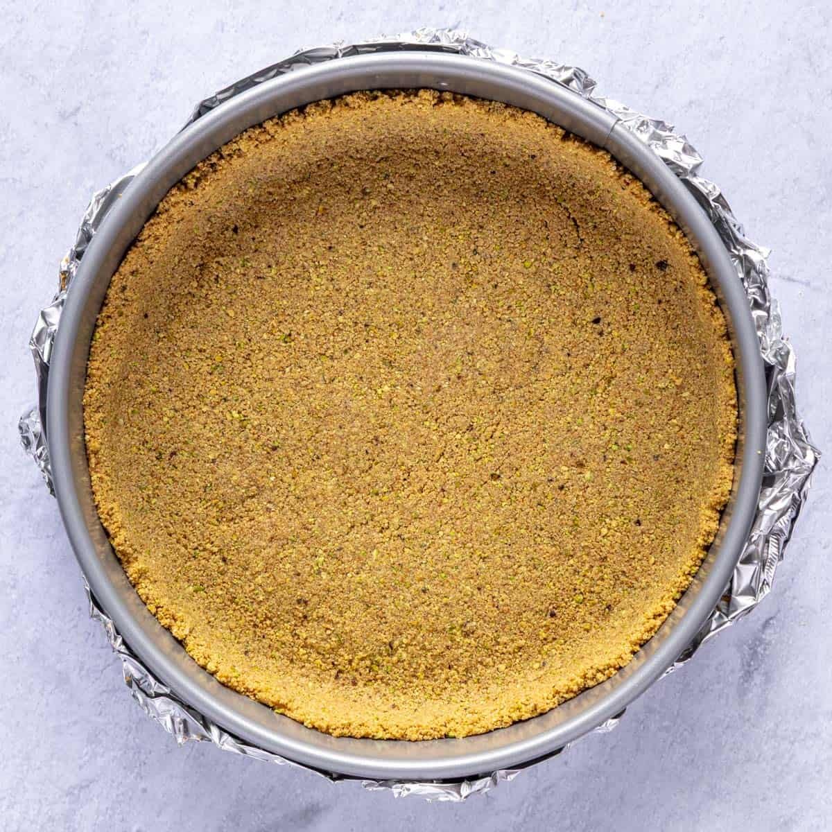 Graham cracker crust in spring form pan after toasting.