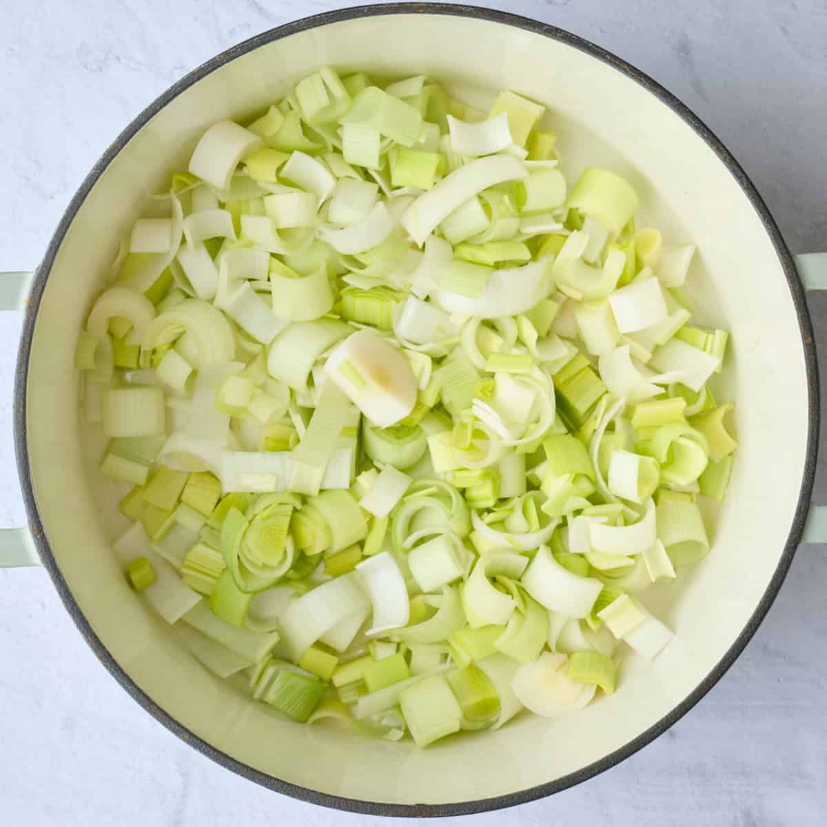 Sliced leeks in a large pot before cooking.