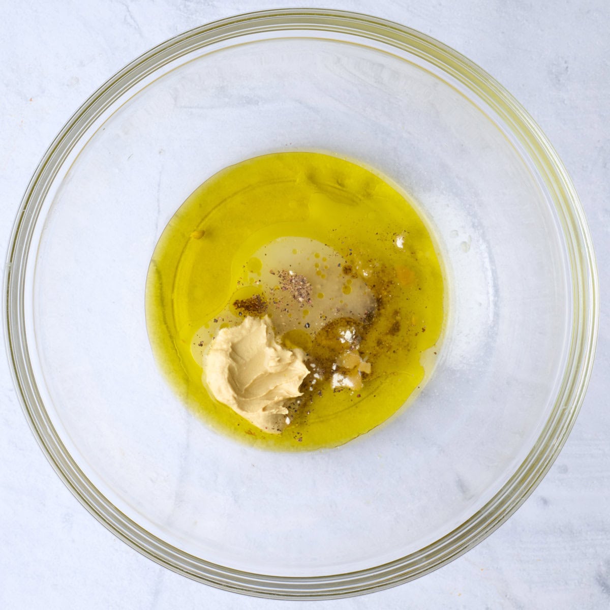 Dressing ingredients in a bowl before mixing.