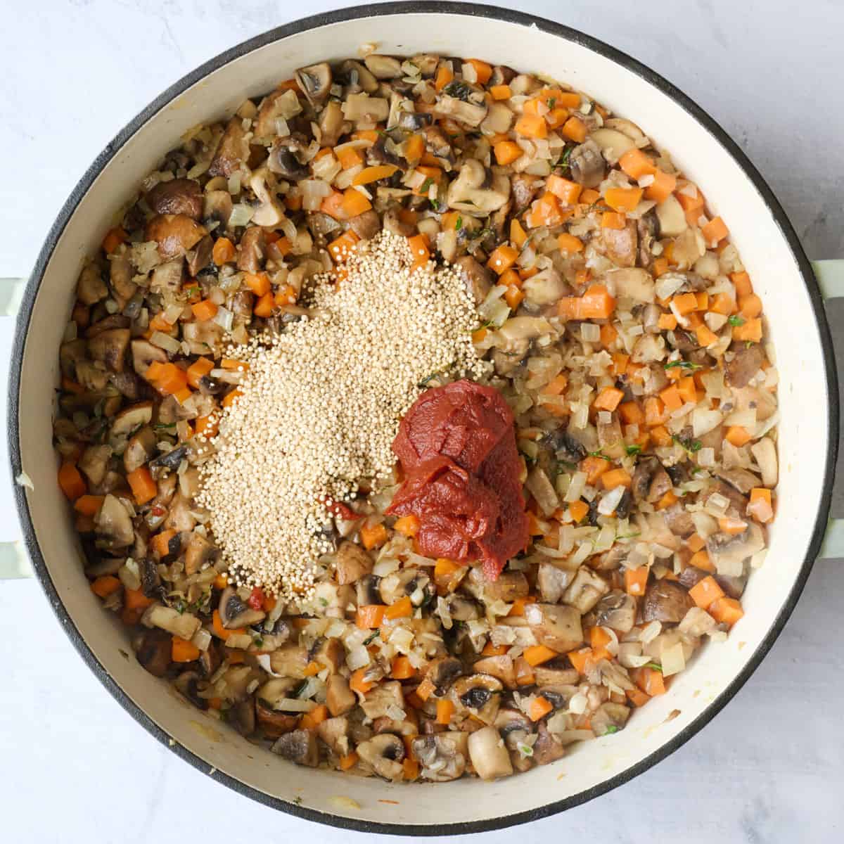 Quinoa and tomato paste added to cooked veggies.