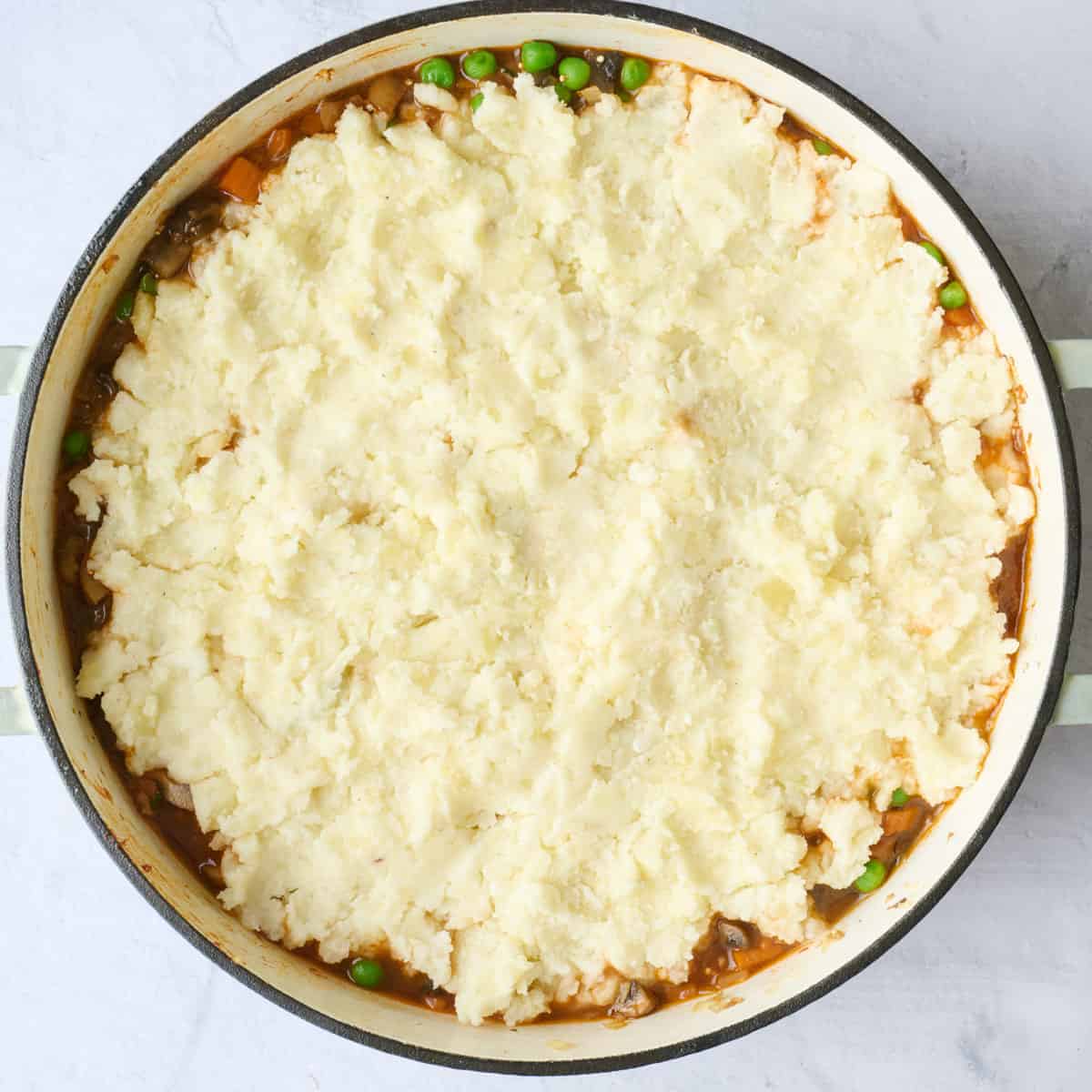 Mashed potatoes added on top of filling for recipe.