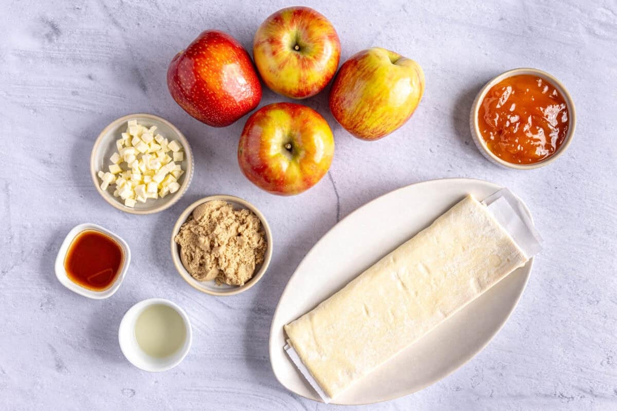Ingredients for recipe: apples, puff pastry, butter cubes, brown sugar, vanilla and lemon juice.