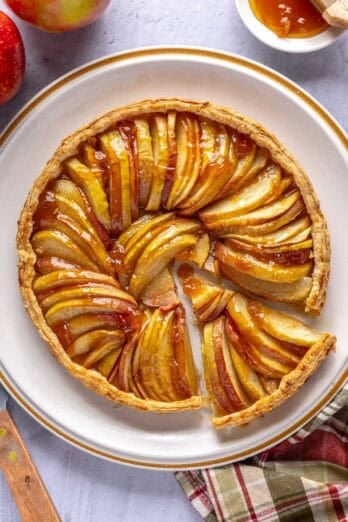 Easy apple tart puff pastry recipe with a slice cut and pulled away.