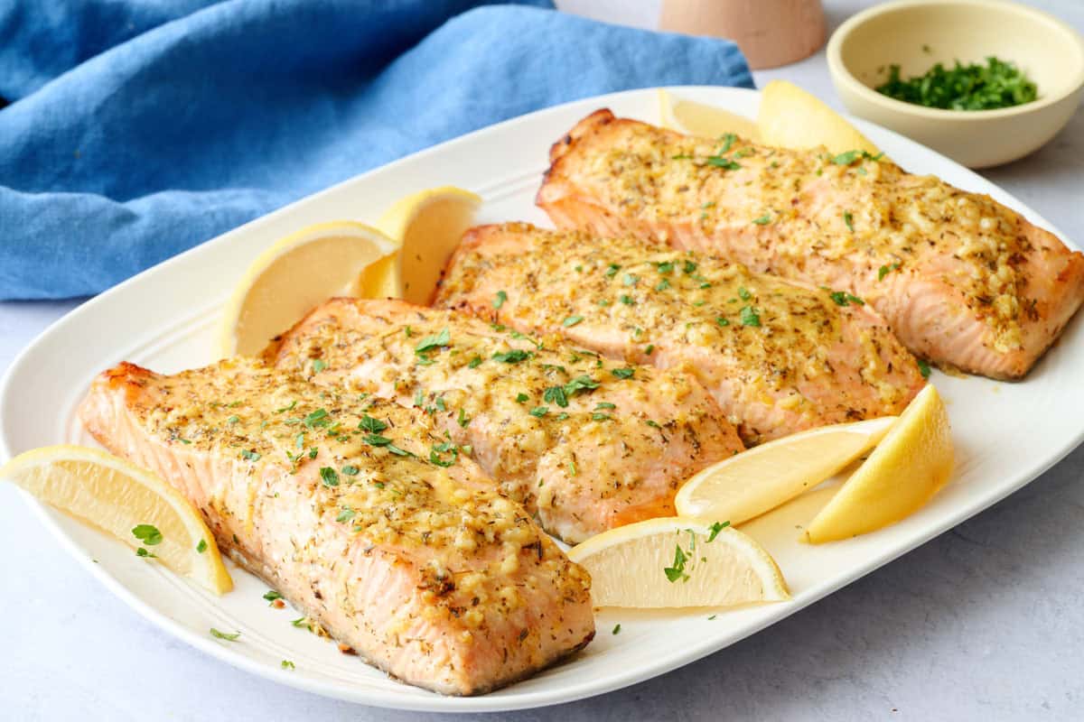 Easy baked salmon recipe served on a platter with lemon wedges.
