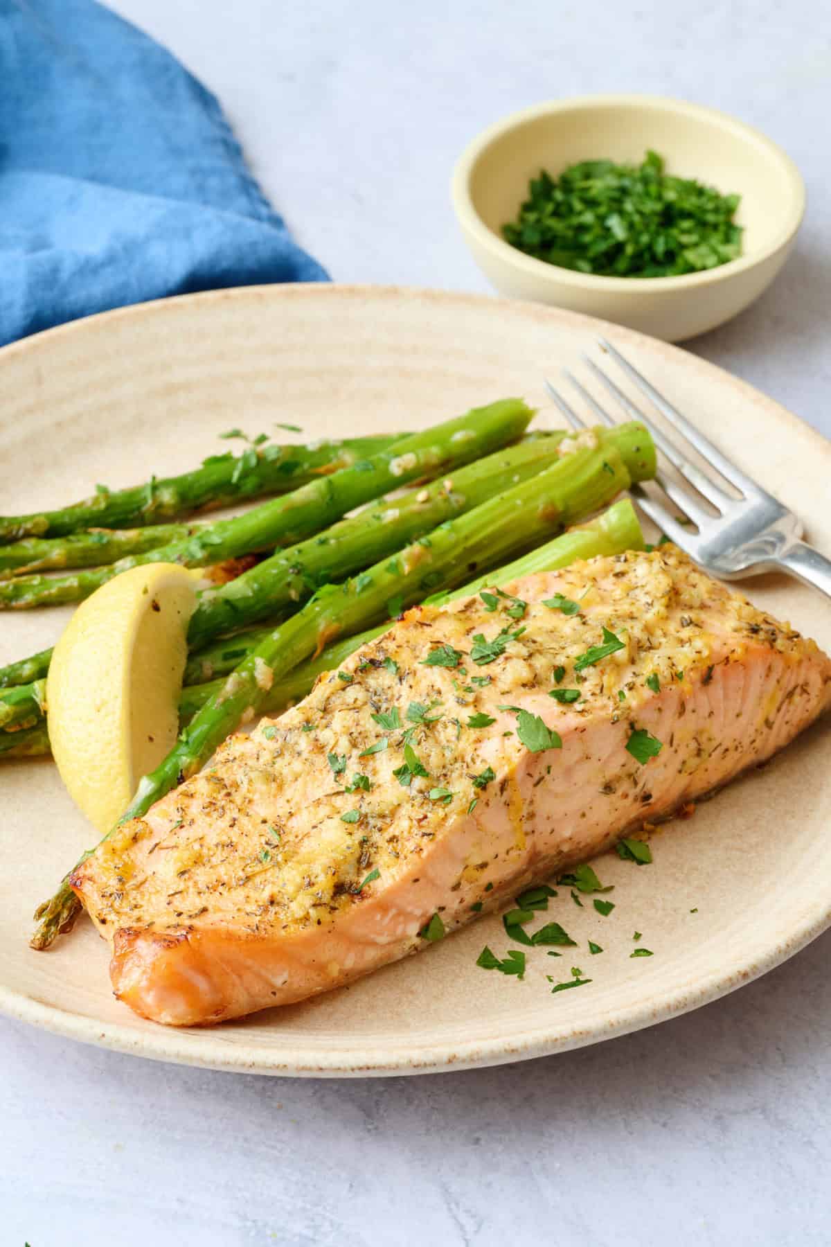 Best baked salmon recipe fillet on a plate with roasted asparagus.