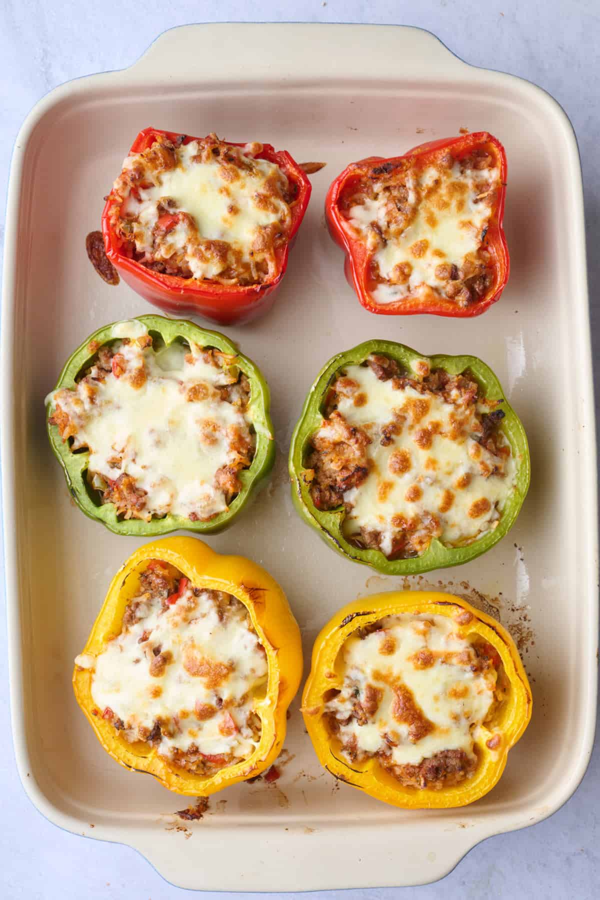 Beef stuffed peppers after baking in a baking dish.