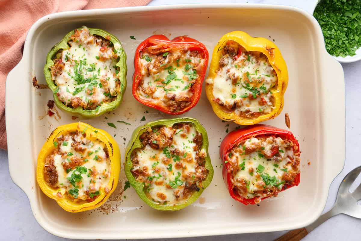 Classic stuffed peppers with ground beef, rice, and tomato filling with melted cheese on top.
