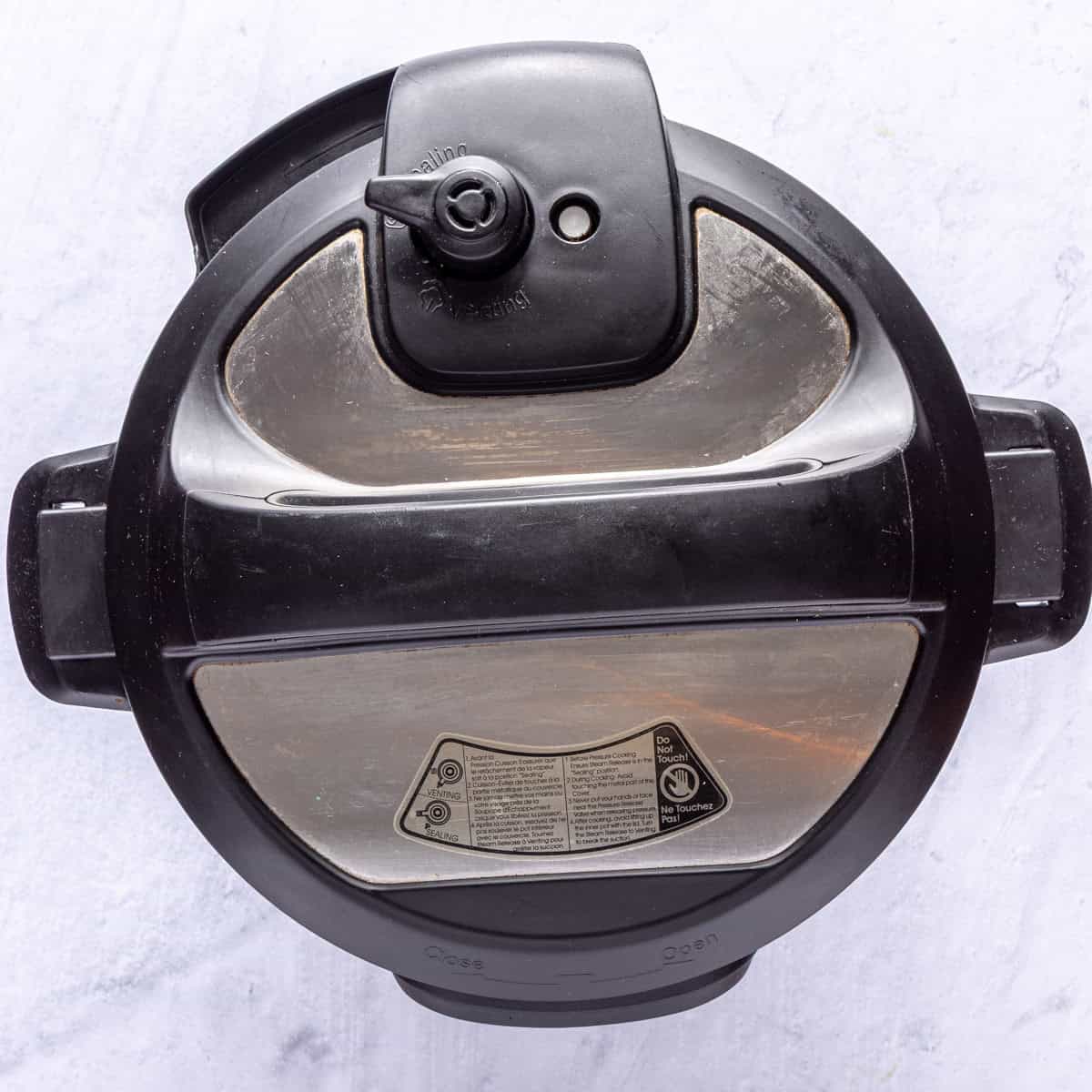 Lid of Instant pot added to machine with the valve closed for hard boiled egg recipe.