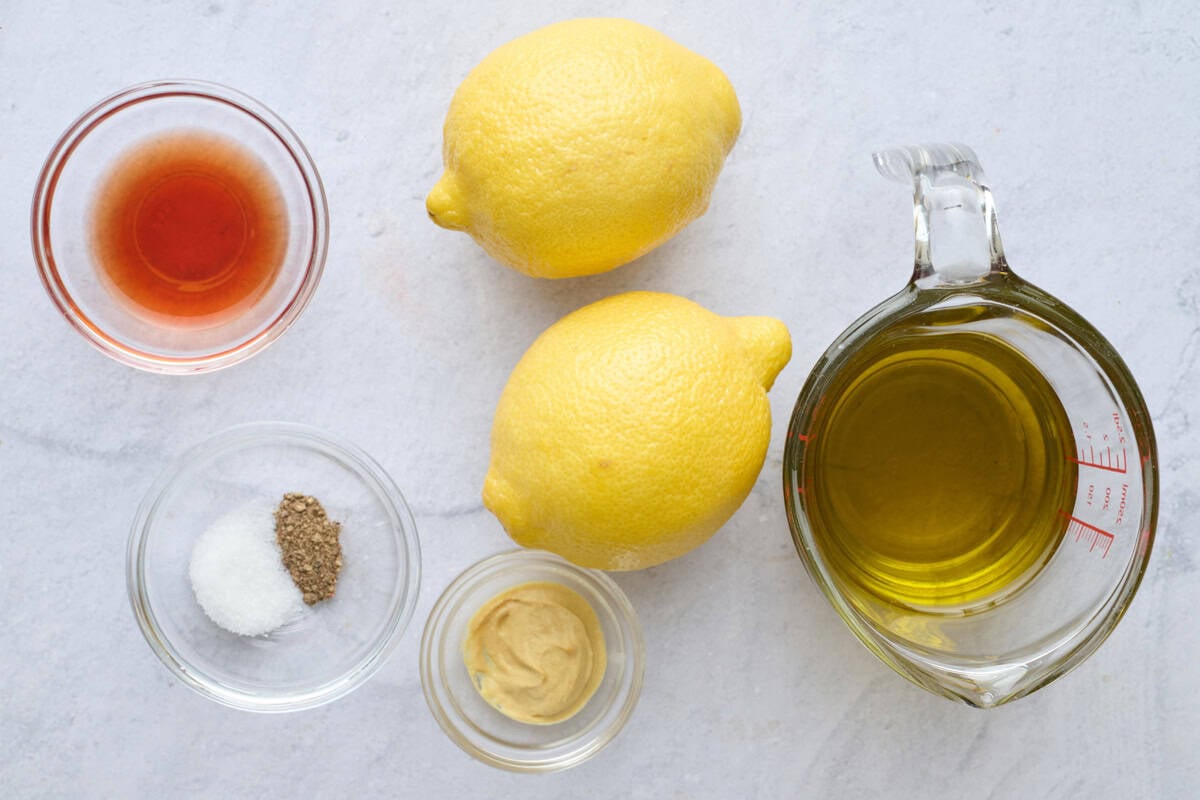 Ingredients for dressing recipe: red wine vinegar, salt and pepper, lemons, Dijon mustard, and oil.