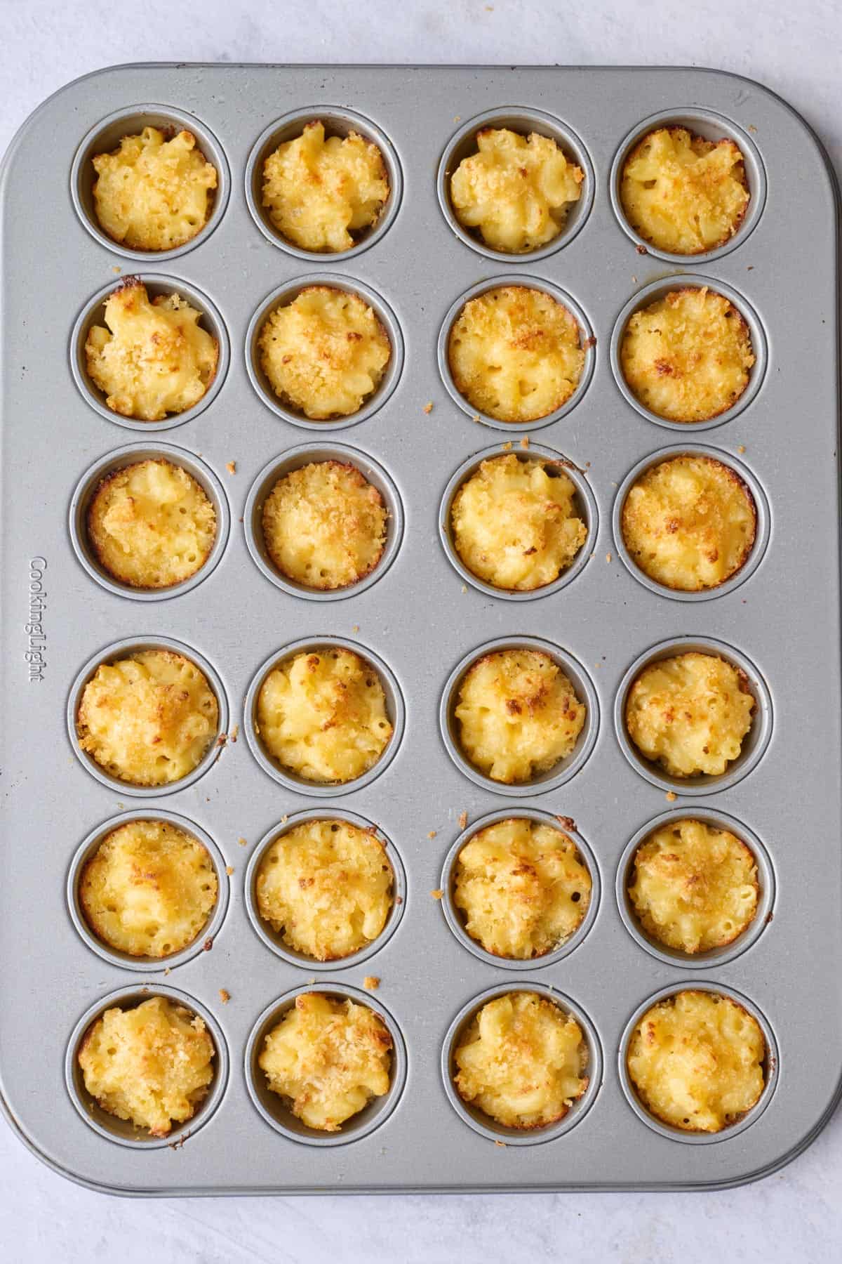 Crispy breadcrumb topped mini mac and cheese bites after baking.